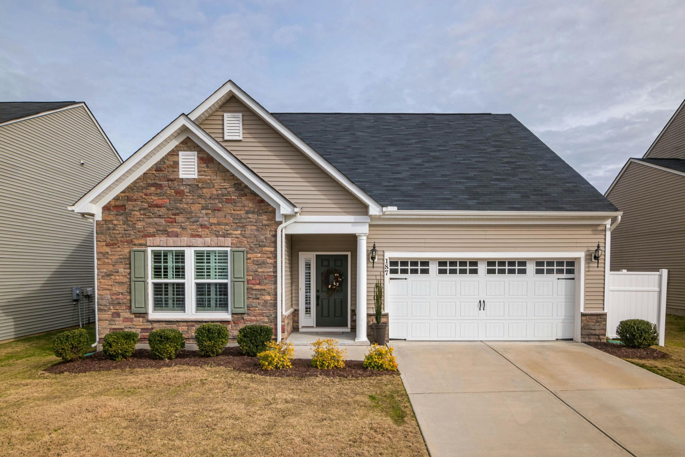 Single-storey brick home with a double garage, driveway and front lawn